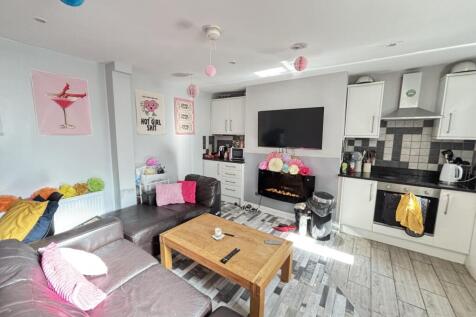 A bright and spacious living room with contempo...