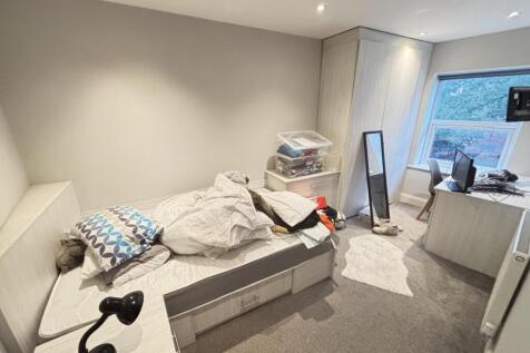 A cozy single bedroom with natural light coming...