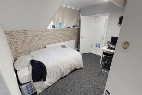 A clean and cozy student bedroom with a comfort...