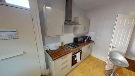 A well-lit modern kitchen featuring ample count...
