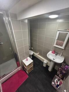 A modern bathroom suite featuring a shower, a s...