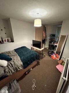 A cozy and lived-in master bedroom featuring a ...