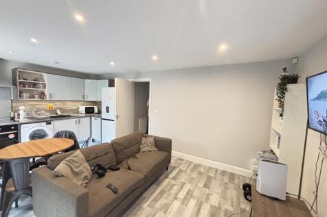 A spacious and modern living room with ample na...