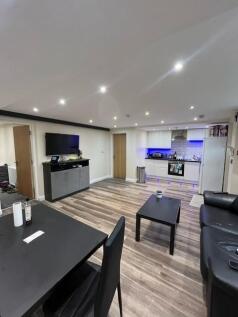 A spacious and modern living room featuring a l...