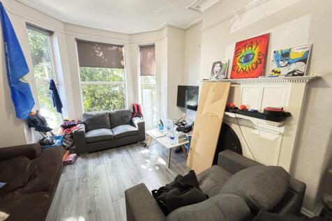 A bright and airy living room featuring large w...