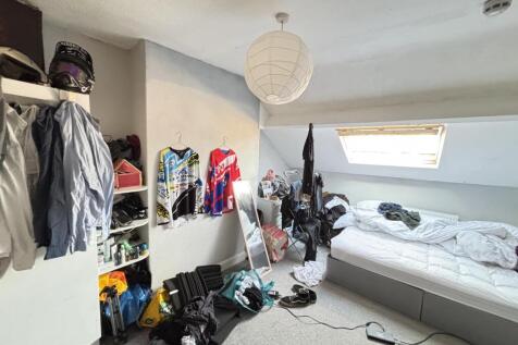 A bright and cozy bedroom with a large window t...