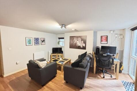 A modern, well-lit living room with comfortable...