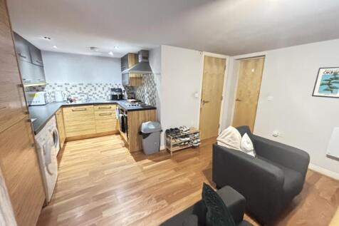 A bright and welcoming living room featuring mo...