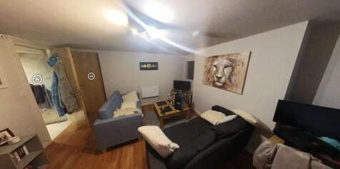 A spacious and well-maintained living room with...