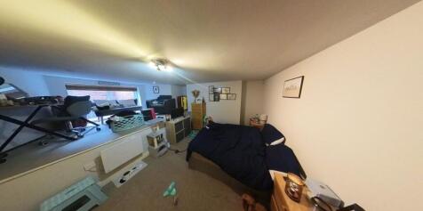 A spacious and well-lit living room with ample ...