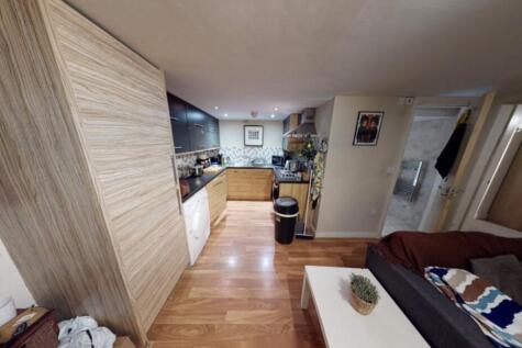 A spacious and well-lit contemporary living roo...