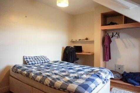 A cozy bedroom featuring a double bed with a st...