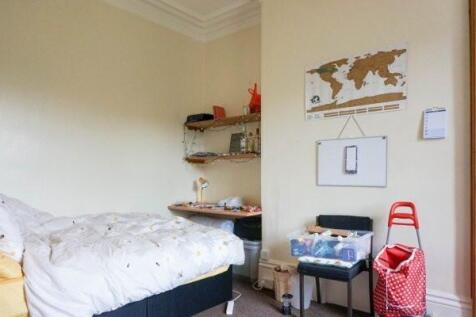 A cozy and well-maintained bedroom featuring a ...