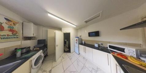 A modern, well-lit kitchen featuring ample work...