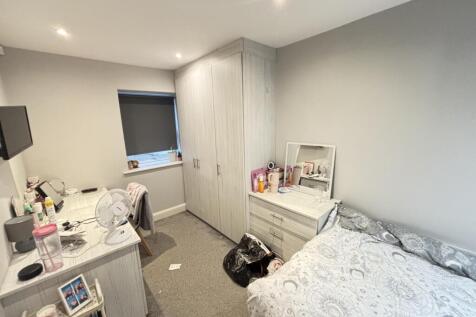 A bright and spacious master bedroom featuring ...