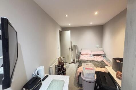 A cozy and well-maintained bedroom featuring tw...