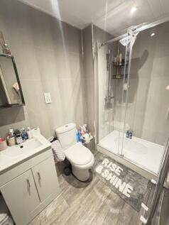 A clean and modern bathroom suite featuring a s...