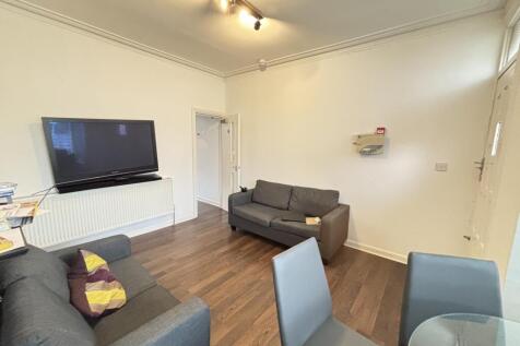 A modern and well-lit living room featuring com...