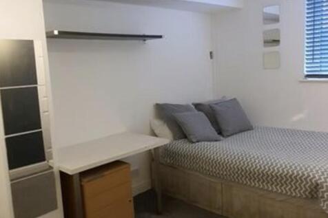 A well-maintained bedroom featuring a double be...