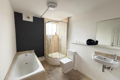 Bright and clean bathroom with a spacious batht...