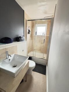 A clean and functional bathroom with a shower, ...