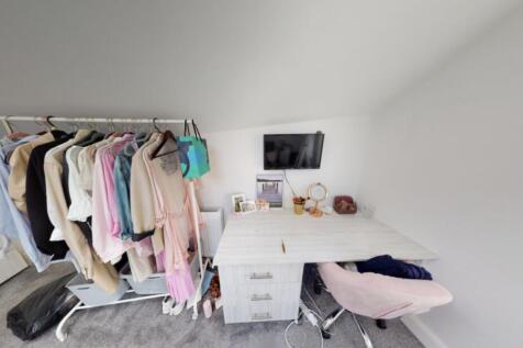 A bright and modern bedroom with a tidy layout,...