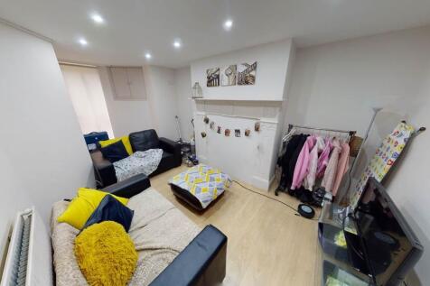 A bright and welcoming living room featuring a ...