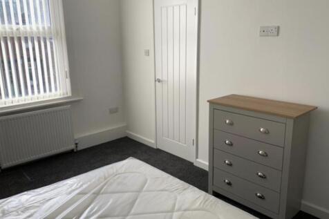 A well-maintained bedroom featuring a clean, ti...
