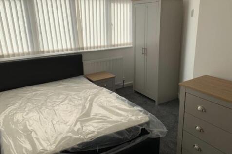 A well-kept bedroom featuring a comfortable dou...