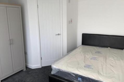 A neat and well-maintained bedroom featuring a ...