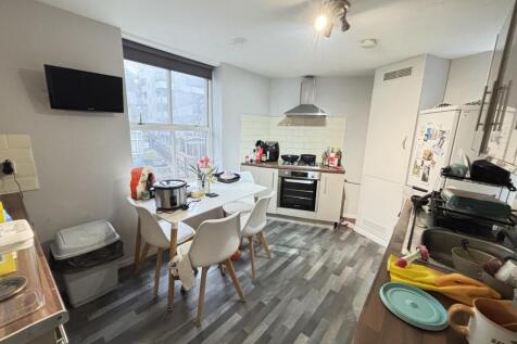 A modern and tidy kitchen space featuring a cen...