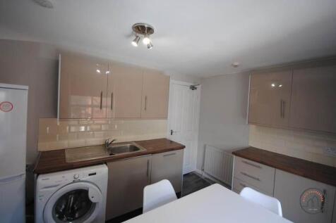 A modern, well-organized kitchen with ample wor...