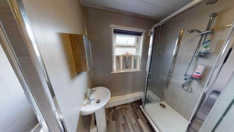 Bright and clean bathroom featuring a shower en...
