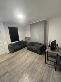 Bright and spacious living room featuring comfo...