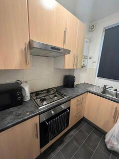 A modern kitchen featuring a black granite coun...