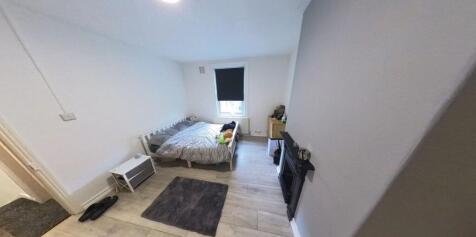 A well-maintained bedroom featuring a double be...