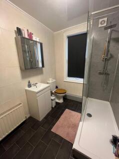 A well-maintained bathroom featuring a spacious...
