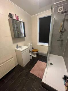 A clean and well-organized bathroom featuring a...