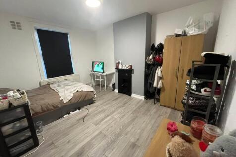 A cozy and well-lit living room with a comforta...