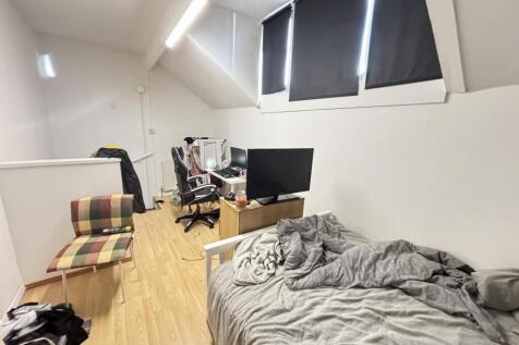 A cozy and functional living area featuring a c...