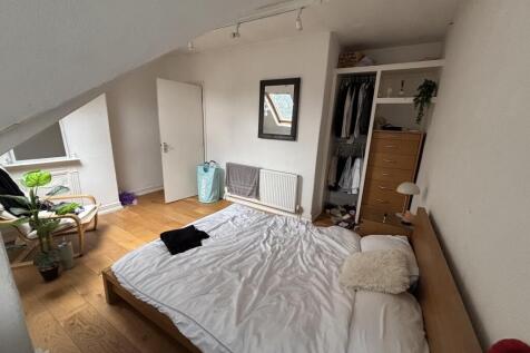 A bright and inviting master bedroom featuring ...