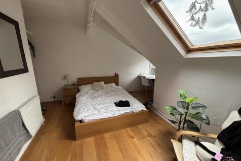 A bright and airy master bedroom with a comfort...