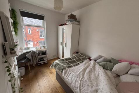 A bright, well-maintained living room with larg...