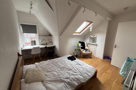 A bright, breezy bedroom featuring a spacious d...