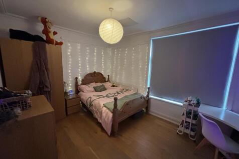 A cozy bedroom featuring a double bed with a so...