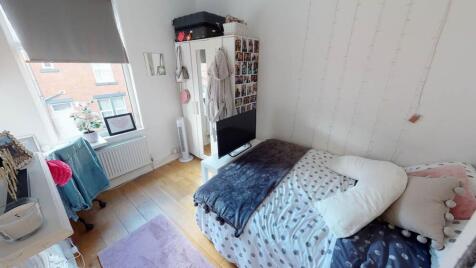 A well-lit, inviting double bedroom featuring a...