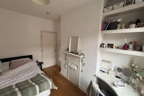 A well-maintained bedroom featuring a comfortab...