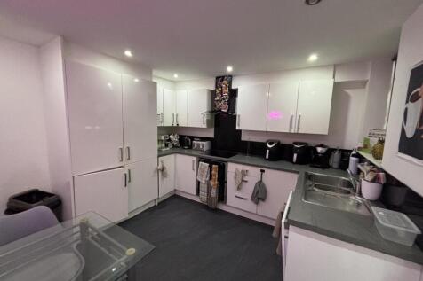 Bright and modern kitchen with ample storage an...