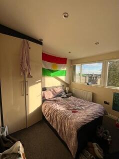 Bright and cozy bedroom featuring a large windo...