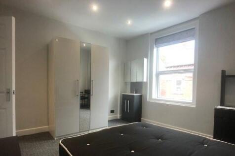 A bright and clean bedroom with a large window ...